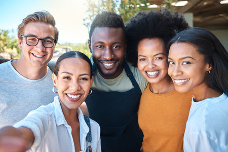 Portrait of diverse friends taking a selfie, bonding and enjoying their freedom outdoors together....