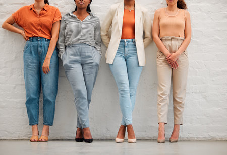 Creative and stylish team of business women against wall together, doing teamwork and collaboration at work. Shoes and legs of professional and corporate employees and workers working at a startupの写真素材