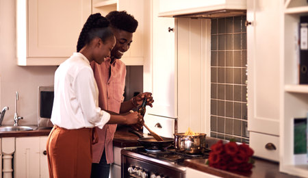 This is gonna be so good. an affectionate young couple cooking together on Valentines day at home.の写真素材
