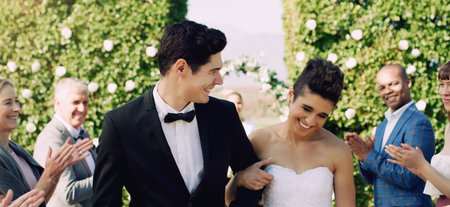 They makes love so easy to believe in. an affectionate young newlywed couple leaving their wedding...