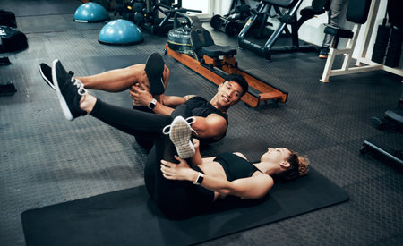 Make the best of every workout. two sporty young people working out together at the gym.