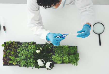 Shes got a few tests to run on this plant. High angle shot of an unrecognizable female scientist...
