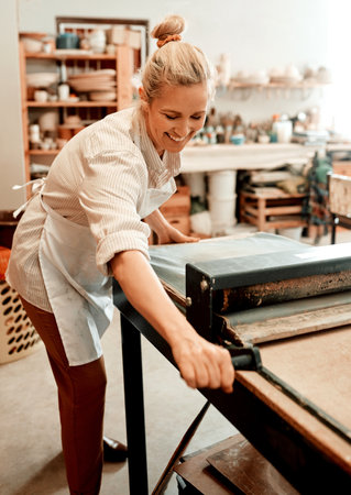Youd smile too if you were a potter. a female artisan working in her pottery workshop.の写真素材