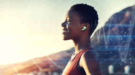 Black woman, outdoor and listening to music in nature with overlay or double exposure of future audio in nature for peace, freedom and peace. Face of female with earphones while streaming soundの写真素材