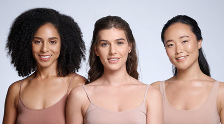 Skincare, makeup and diversity of women with beauty, marketing cosmetics and dermatology advertising on a studio background. Body spa, luxury and face portrait of model collaboration for skin healthの写真素材