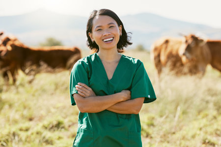 Woman, vet or arms crossed on cow farm, dairy agriculture field or beef produce countryside in wellness goals or vaccine innovation. Portrait, smile or happy animal doctor in bovine cattle healthcareの写真素材