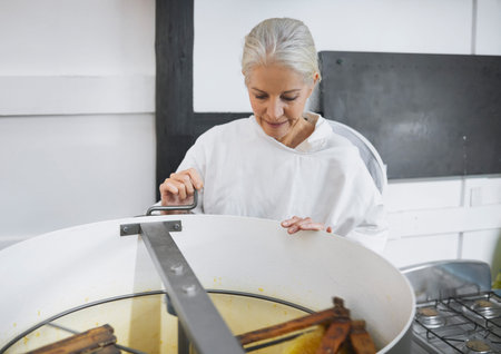 Beekeeper woman, factory and honey production with machine, focus and working in apiculture...