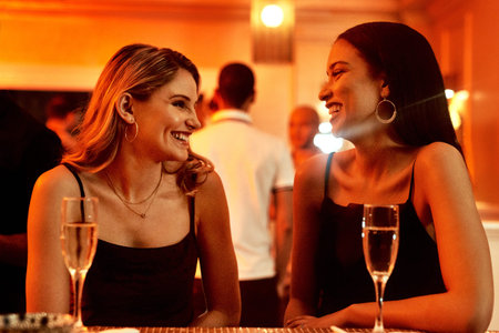 They always have a lot of banter together. two cheerful young women chatting while having drinks...