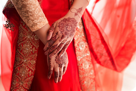 Mehndi design thatll make heads turn. an unrecognizable woman with mehendi painted on her hands on her wedding day.の写真素材