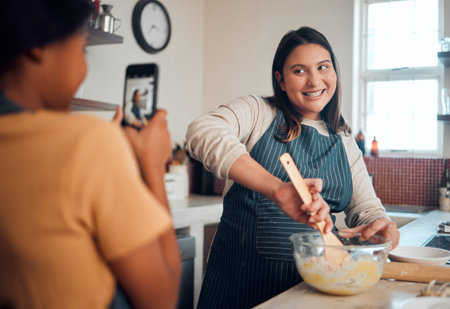 Baking, tutorial and social media with a chef woman in the kitchen of her home cooking as an...