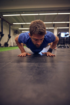 Im determined to create the body I want. Full length shot of a handsome young man doing pushups...