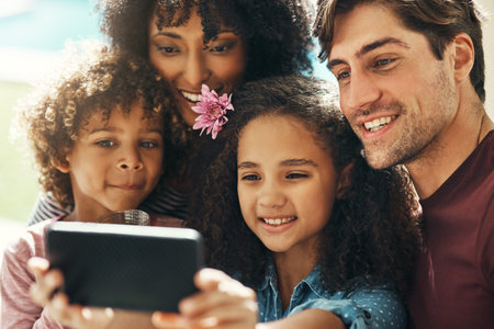 Family photos always look the best. a beautiful young family taking a selfie together outdoors.