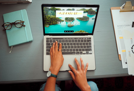 Laptop, hands and travel planning of woman online with international holiday trip screen top view. Vacation, adventure and journey organisation of girl busy with internet research on digital device.の写真素材