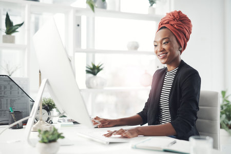 Shes dedicated to her goals. an attractive young businesswoman working at her desk in the office.の写真素材