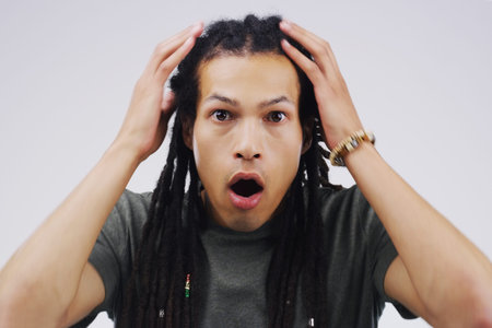 That just blew my mind. Studio portrait of a handsome young man looking shocked against a grey...