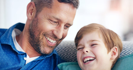 Having the best of times with my little man. a cheerful father and son relaxing on a couch and...