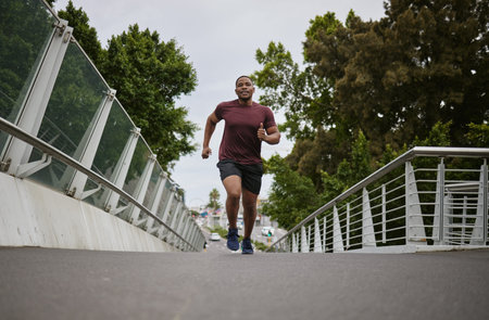 Black man running on bridge in city for fitness, exercise and healthy goals, sports wellness and...