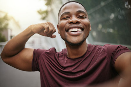 Selfie, smile and fitness arm flex of a black man athlete ready for running, workout and exercise....