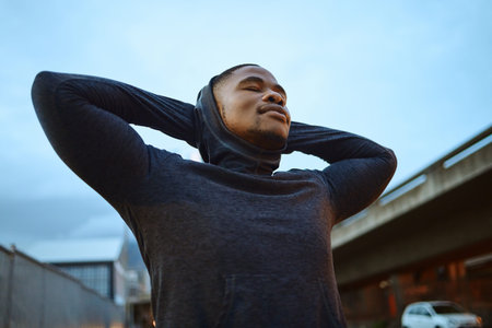 Black man, rest after running and exercise for morning, training and fitness. African American male, athlete or runner on break, workout and relax for practice, outdoor exercise or wellness for powerの写真素材