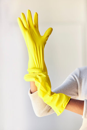 Cleaning gloves, hands and woman in home ready to sanitize for hygiene, wellness and health. Spring...