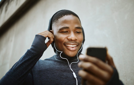 Music, phone and running with black man in city for streaming, podcast and mobile radio. Workout,...