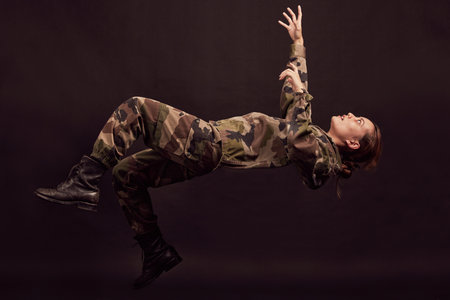 Anxiety, soldier and woman in studio for war ptsd, nightmare and horror, mental health and depression on black background. Military, flashback and girl in army crisis, trauma and fall Ukraine veteranの写真素材