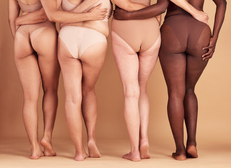 Women group, lingerie and butt in studio for wellness, fashion and diversity with plus size in unity. Back, bum and woman model team with solidarity, body positive or health for beauty by backgroundの写真素材