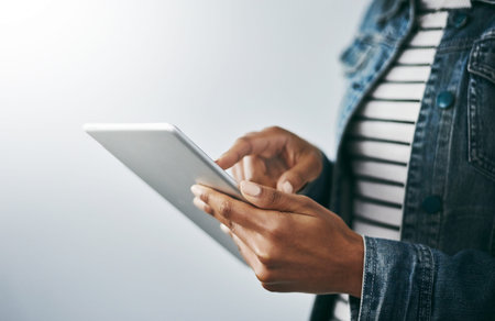 Connect from anywhere. Studio shot of an unrecognizable young woman using her digital tablet against...