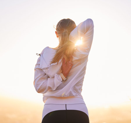 Fitness, stretching and woman exercise at sunset for training, wellness and running in nature, rear...