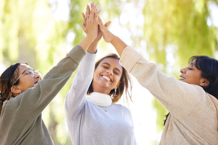 Friends, park and high five with joy in celebration for love, care and affection in nature. Female...