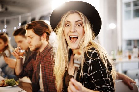 I love a good time. a young woman enjoying herself at a get together between friends.