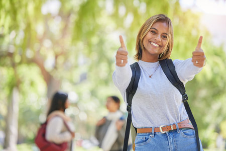 Young woman, thumbs up and university student, yes and success in education, academic study and to learn mockup. Agreement, smile and scholarship with degree, learning and portrait on New York campusの写真素材