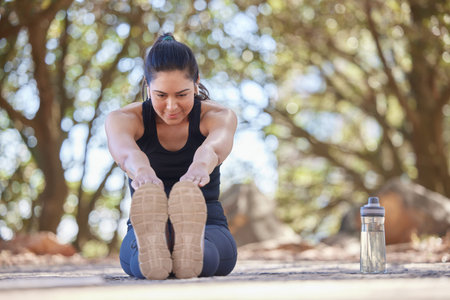 Woman, fitness and stretching leg, exercise and training outdoor for health, wellness and healthy...
