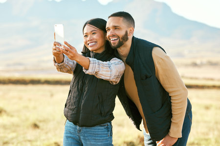 Selfie, couple and travel to countryside, outdoor and happy with phone for photography on holiday in...