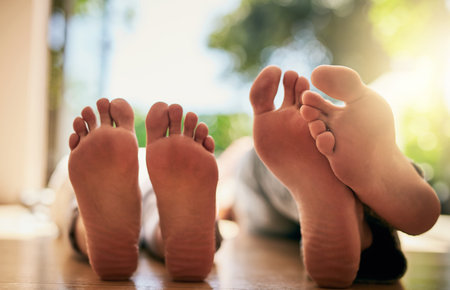 Just chilling. Closeup shot of an unrecognizable couples bare feet.