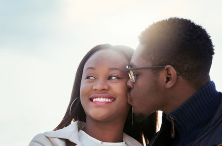 My love is all yours. an affectionate young couple bonding together outdoors.の写真素材