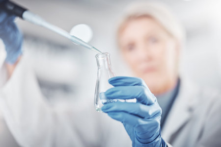 Science, chemistry and beaker with woman in laboratory for research, dna and vaccine analysis....