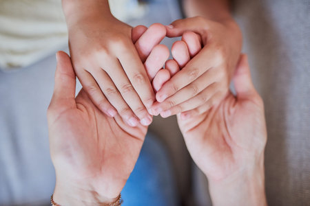 Hold my hand, know Ill always be here for you. High angle shot of a mother and son holding hands at...
