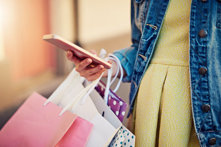 Looking for the next sale in town. an unrecognizable woman on a shopping spree in the city.の写真素材