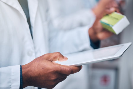 Healthcare, hands and pharmacist with tablet and medicine checking prescription online in pharmacy inventory. Medical insurance, drugs and man with digital stock checklist at pharmaceutical store.の写真素材