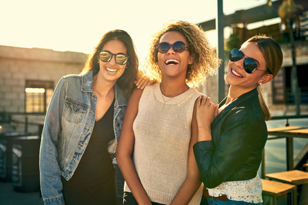 When in doubt, go outside and live it up. three female best friends spending the day outside on a...