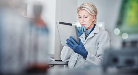 Tablet, thinking and science with a doctor woman at work in a lab for research, innovation or...