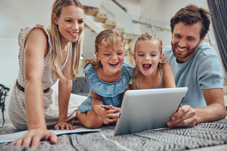 Tablet, children and education video with parents at home helping with elearning technology care. Parent love, girl and happy study learning app with kids streaming e learning games with mom and dadの写真素材
