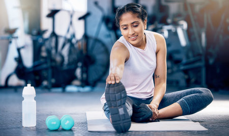 Stretching, fitness and water bottle with woman in gym for weightlifting, exercise and sports...