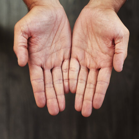 Your hands shows that you are healthy. Studio shot of an unrecognizable persons open hands shown against a dark background.の写真素材