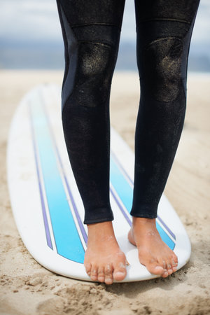 Practice makes perfect. an unrecognizable female surfers feet on a surfboard.の写真素材