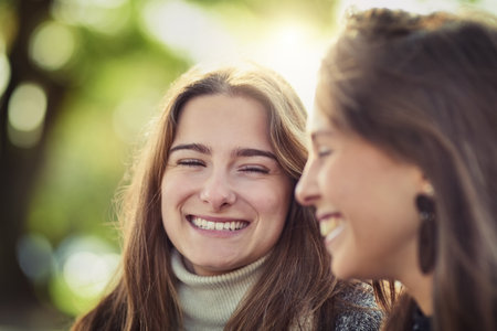 Best friends, through thick and thin. two attractive young women spending the day outdoors.の写真素材
