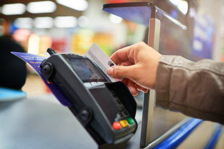 Just swipe and pay. an unrecognizable woman making payment in a store.の写真素材