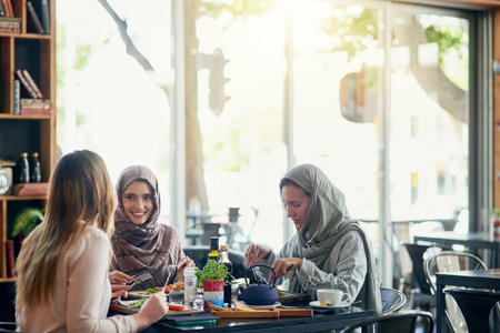 Brunch with the besties. a group of women getting together for lunch in a cafe.の写真素材