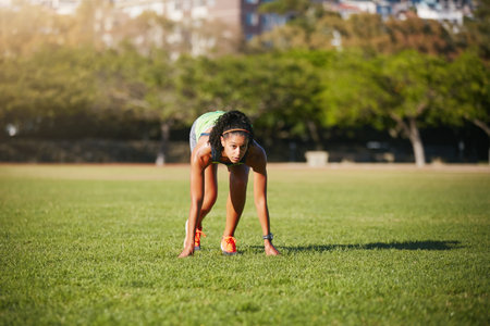 Eyes on the prize. a sporty young woman exercising outdoors.の写真素材